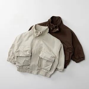 Detailed flat lay of children's cotton work jackets in beige and dark coffee colors