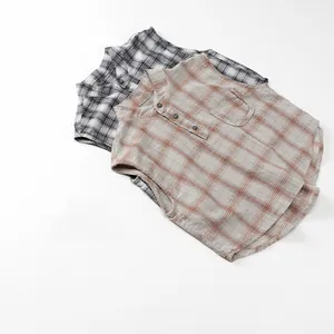 Detailed view of plaid sleeveless shirts with cotton texture and three-button collar