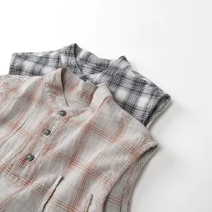 Detail view of cotton linen plaid sleeveless shirts in beige and grey grid patterns