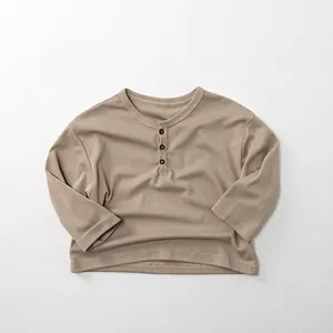 Close-up of soft cotton kids long sleeve Henley shirt with classic three-button neck detail