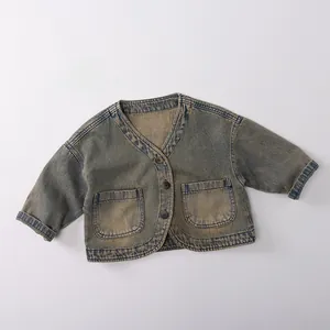 Detail of vintage blue-grey kids denim cardigan with V-neck and wooden buttons