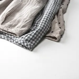 Detailed close-up of cotton linen fabric textures in stripe, plaid, and dotted patterns