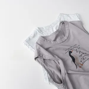 Close-up of two cotton toddler tank tops in grey and purple with penguin graphic
