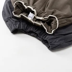 Kids cotton wide-leg pants in grey and olive green featuring elastic waist with drawstrings