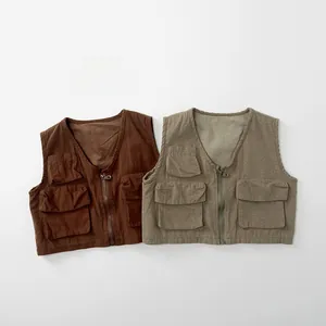 Close-up of kids retro cotton vests in brown and olive with three utility pockets
