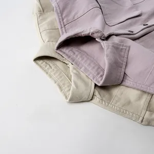 Vue détaillée de chemises en coton respirant beige et lavande avec col à boutons