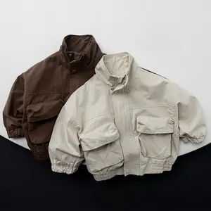 Detailed view of kids cotton utility jacket featuring large front pockets and elastic hem