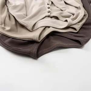 Detail of soft cotton kids' henley neck sweaters with three buttons and neat stitching