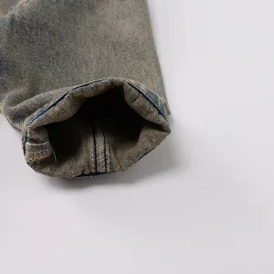 Detailed macro view of vintage yellow-wash denim fabric and sturdy inner stitching