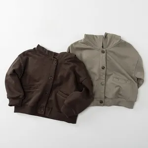 Flat lay of knit hooded cardigans for kids in coffee and olive green colors