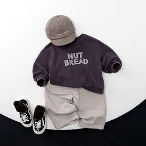 Kids cotton loose joggers set with purple sweatshirt and gray pants flat lay view