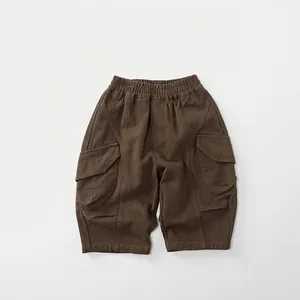 Detail of children's cotton cargo pants featuring elastic waistband and large side pockets