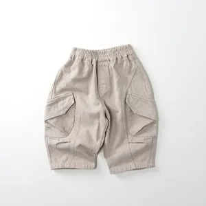 Detailed close-up of elastic waistband and cargo pockets on cotton kids trousers