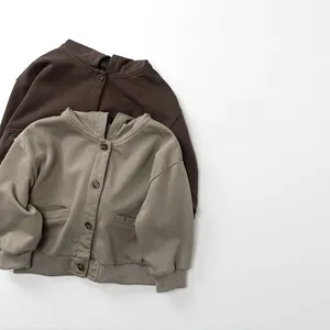 Detail of kids knit hooded jackets in dark coffee and olive green with button closures