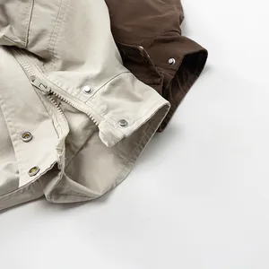Detail view of cotton cargo jacket featuring zipper closure and metal snap buttons