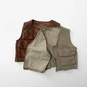 Detail of cargo-style cotton vests showing multiple flap pockets and metallic zippers