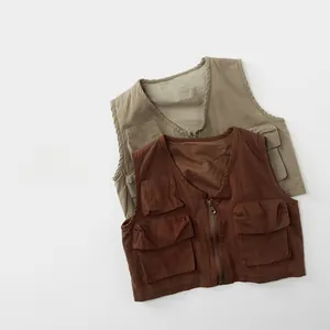 Detail of vintage utility vest showing durable canvas fabric and cargo pockets