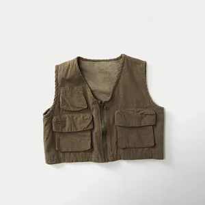 Detailed close-up of a vintage utility vest featuring multiple pockets and durable cotton fabric