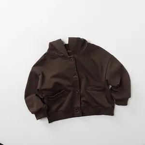Detail view of children's dark brown hooded knit cardigan with button closure and pockets