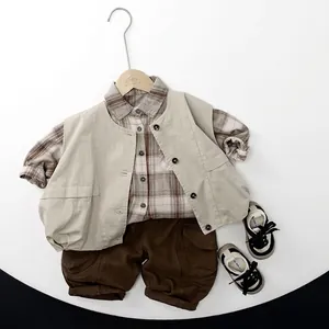 Kids autumn earth tone outfit with beige cargo vest, plaid shirt and brown joggers