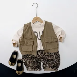 Kids three-piece set with olive utility vest, leopard pants, and beige long-sleeve tee