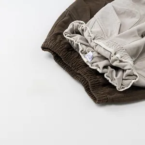 Detailed macro view of elastic drawstring waistbands on cotton cargo pants for kids