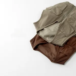 Detail of khaki and tan children's workwear vests with pockets and zippers