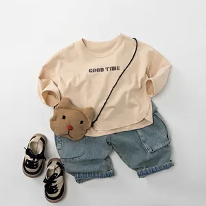 Children's autumn casual outfit featuring beige graphic sweatshirt and denim jeans