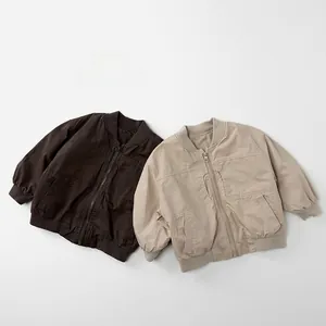 Flat lay view of kids' cotton pilot jackets in dark brown and light beige colors