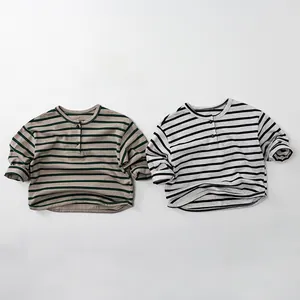 Detail of striped cotton long-sleeve kids T-shirts with Henley neck and button accents