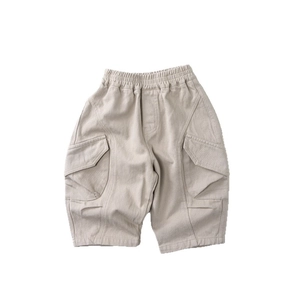 Kids loose fit cotton cargo pants with elastic waist and side flap pockets in beige
