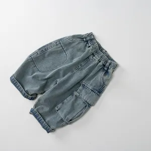 Detail of retro washed blue kids denim shorts with elastic waist and cargo pockets