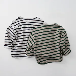 Detail of soft cotton striped kids shirts featuring ribbed crew neck and rolled cuffs