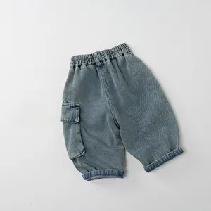 Detail showing elastic waistband and large side cargo pocket on blue kids denim pants