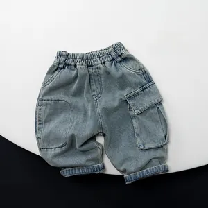 Detail of light blue denim cargo shorts with elastic waist and large side pockets