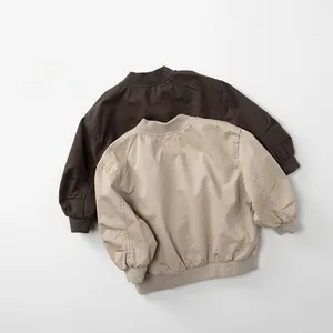 Close-up of children's cotton bomber jackets with ribbed collar and textured fabric