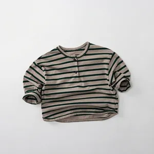 Close-up of green and grey striped cotton long-sleeved shirt with buttoned henley neck