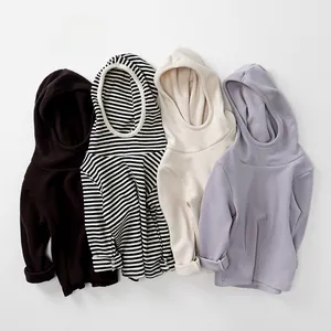 Detailed close-up of hooded kids' thermal shirts in black, striped, cream, and lavender