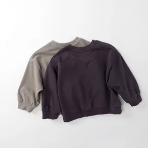 Detail of premium cotton ribbed cuffs and collars on purple and taupe kids sweatshirts