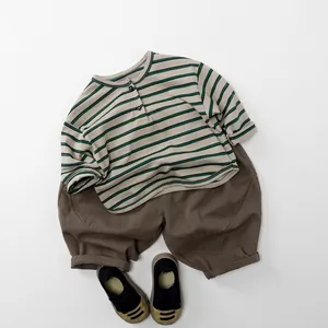 Kids striped long sleeve T-shirt and loose brown pants set with casual shoes on white background