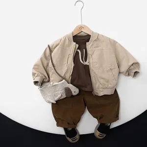 Minimalist beige bomber jacket set for kids with brown trousers and dog knit bag