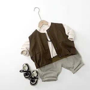 Tenue d'automne enfant avec gilet utilitaire marron, pull beige et short gris