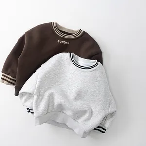 Detail of kids thick fleece sweatshirts with striped cuffs and SUNDAY embroidery