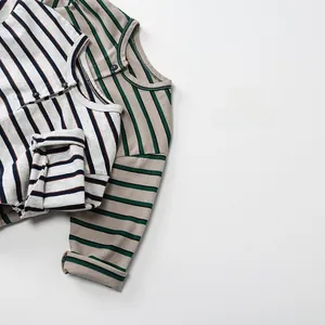 Detail view of the button neckline and striped knit texture on kids long sleeve t-shirts