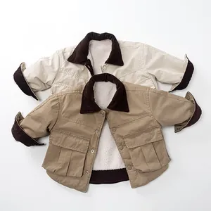 Detail of baby reversible sherpa fleece jacket with corduroy collar and large cargo pockets
