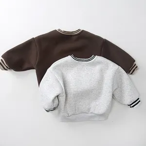 Close-up of contrast striped ribbed cuffs and collar on kids fleece sweatshirts