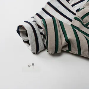 Close-up of rolled cuffs on striped cotton knit shirts for kids showing texture