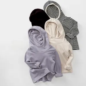 Detail view of children's hooded sweatshirts in lavender, beige, black, and striped patterns