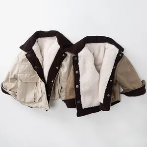 Detail of reversible fleece jackets with corduroy collars and button closures for kids