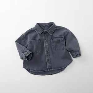 Detail of washed charcoal grey denim shirt for kids with double pockets and buttons